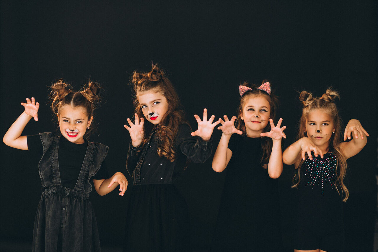 Children in Halloween costumes at a dance studio